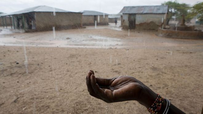 Mujer recoge agua de lluvia en Kenia, África.
