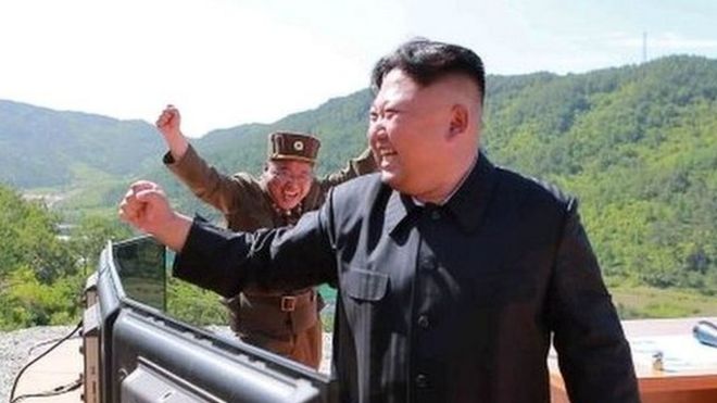 North Korean leader Kim Jong-un (right) reacts during the test of the Hwasong-14 missile in this undated photo released by North Korea's KCNA news agency on 4 July 2017