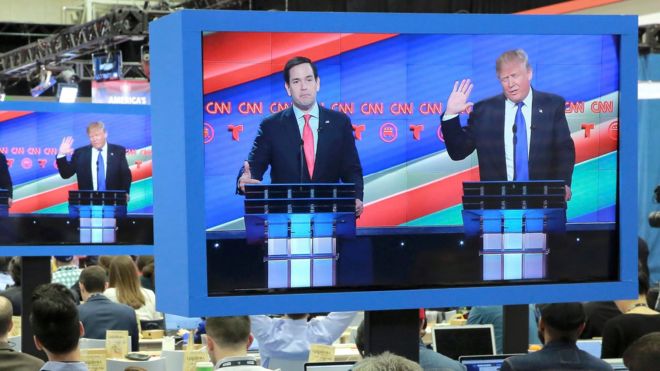 Republican U.S. presidential candidate Donald Trump (L) listens as Senator Ted Cruz speaks at the debate sponsored by CNN