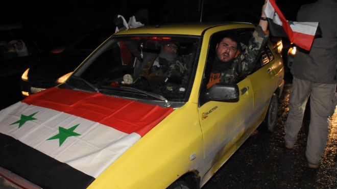 A Syrian driver in Aleppo celebrates on 22 December 2016