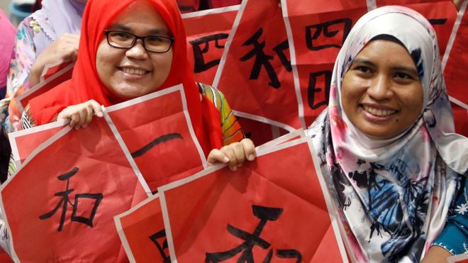 Malay teachers in Kuala Lumpur pose at a Chinese calligraphy event in conjunction with the upcoming Year of the Pig