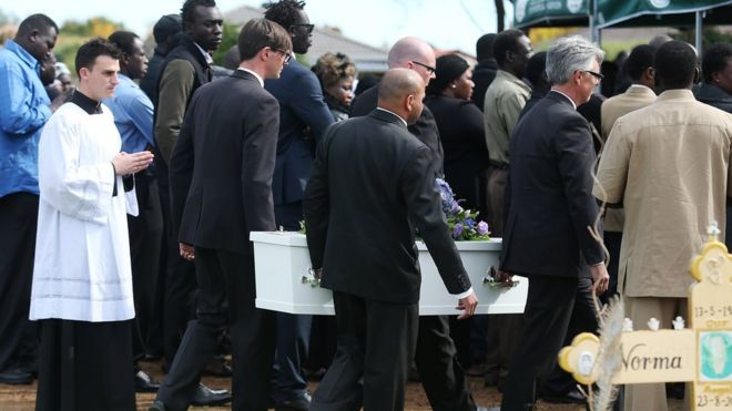 Mourners attend a funeral service for the three children in 2015