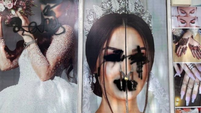 A poster of a bride with her eyes and mouth painted over