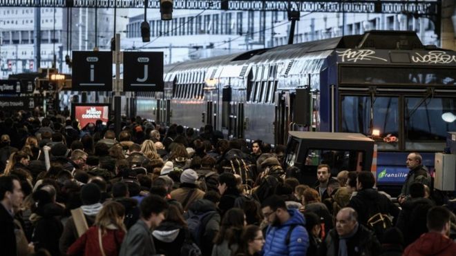 Travellers walk on a platform at the Gare de Lyon railway station in Paris on December 20, 2019