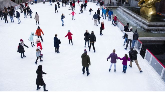 People skate at the ice-skating rink at Rockefeller Center