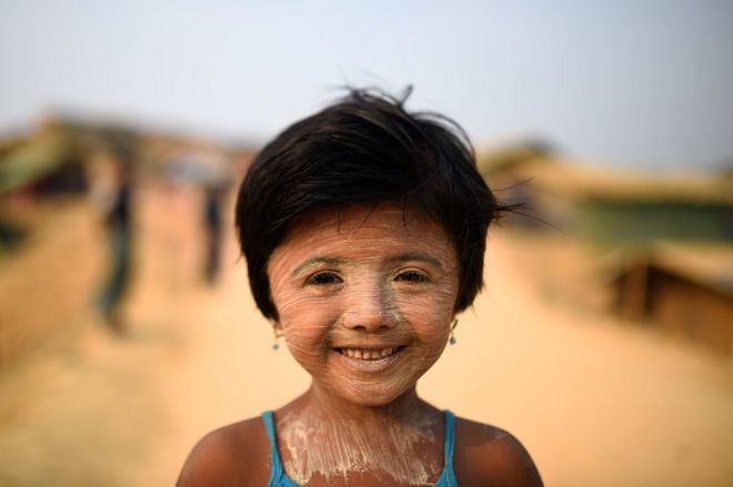 6-летняя беженка из рохингья Нур Каяс позирует фотографу, когда она носит пасту Танака в лагере Кутупалонг на базаре Кокса, Бангладеш