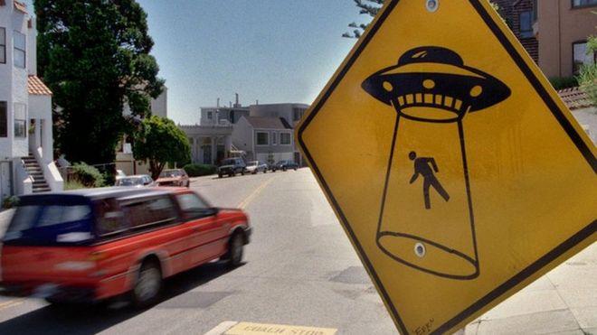 A sign in San Francisco shows an alien abduction