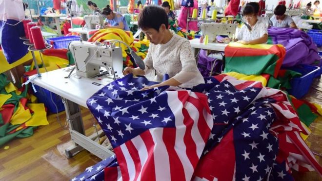 Chinese employees sew US flags at a factory in Fuyang