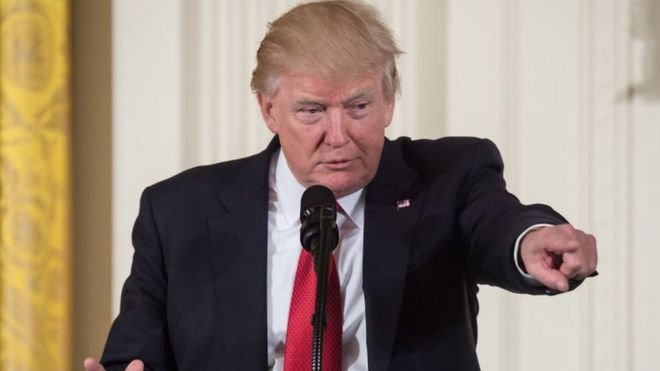 Donald Trump points during a press event.