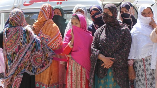 Relatives of the victims of a mass killing look on