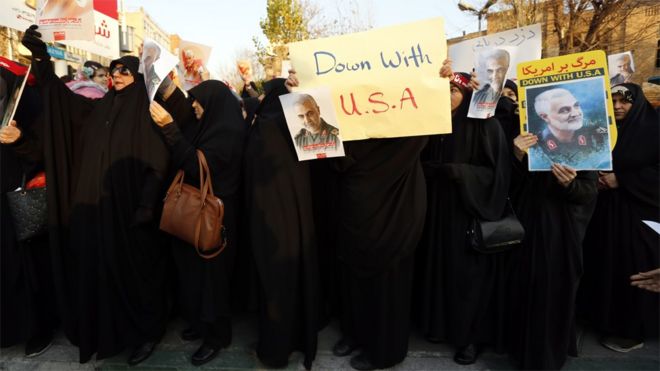 Iranian women hold up anti-US posters at a protest outside the British embassy in Tehran, Iran (12 January 2020)