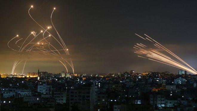 Rockets are seen in the night sky fired towards Israel from Beit Lahiya in the northern Gaza Strip (14 May 2021)