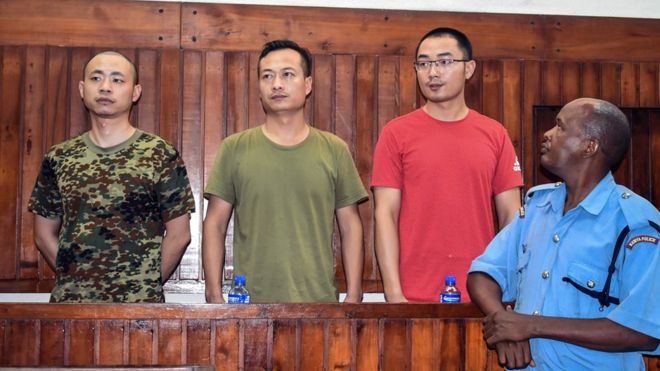 Chinese employees of China Roads and Bridge Corporation at the Standard Gauge Railway (SGR), security manager Li Gen (L), security magager Li Xiaowu (2ndL) and translator Sun Xin (2ndR) appear on November 26, 2018 at Mombasa"s Court, Kenya, charged with bribery.