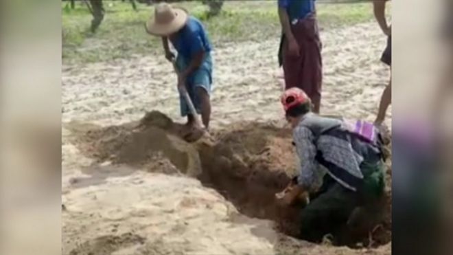 Men digging up graves in Myanmar