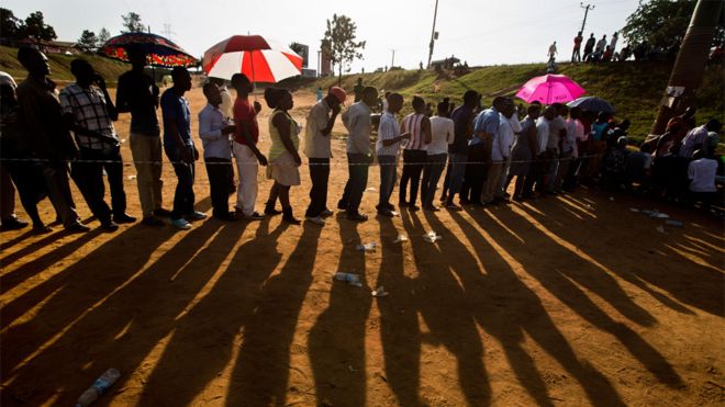 Угандийцы продолжают стоять в очереди, чтобы отдать свои голоса на закате в столице страны Кампале, Уганда, 18 февраля 2016 года