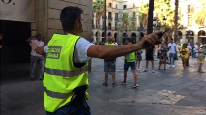 Local policeman tells tourists and residents to move away from the Ramblas