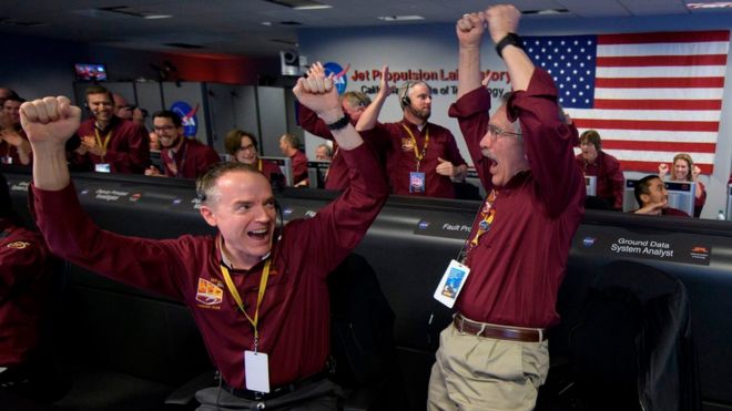 Mars InSight team members Kris Bruvold (L) and Sandy Krasner react after receiving confirmation that the Mars InSight lander successfully touched down