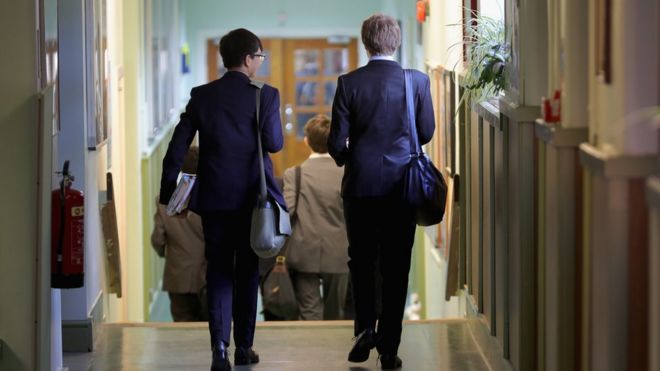 Two school children walking in a corridor