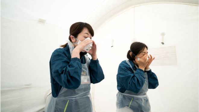Медицинский персонал готовит оборудование для тестирования перед проведением скрининга потенциальных пациентов с коронавирусом COVID-19 в больнице общего профиля Кавакита 17 апреля 2020 года в Токио, Япония.