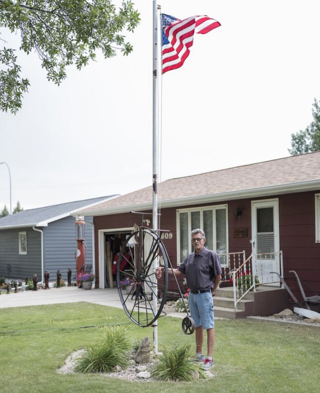 Мужчина стоит рядом с американским флагом