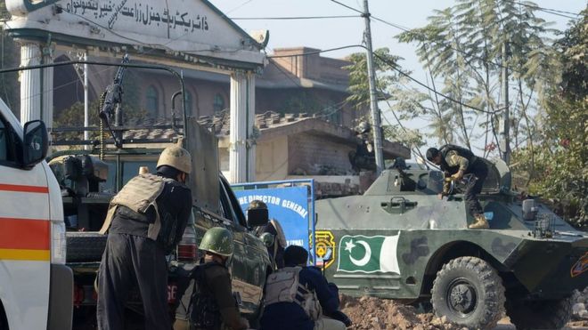 Pakistani security personnel take position outside an Agriculture Training Institute after an attack by Taliban militants in Peshawar on 1 December 2017.