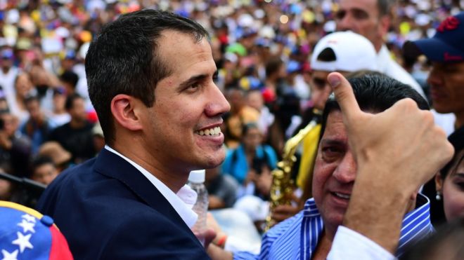 Venezuelan opposition leader and self-proclaimed acting president Juan Guaido gives the thumbs up during a rally upon his arrival in Caracas on March 4, 2019
