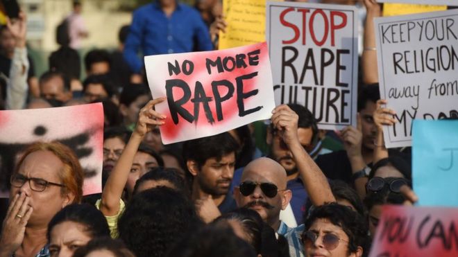 Indian demonstrators hold placards during a protest against rape in Mumbai on April 15, 2018.