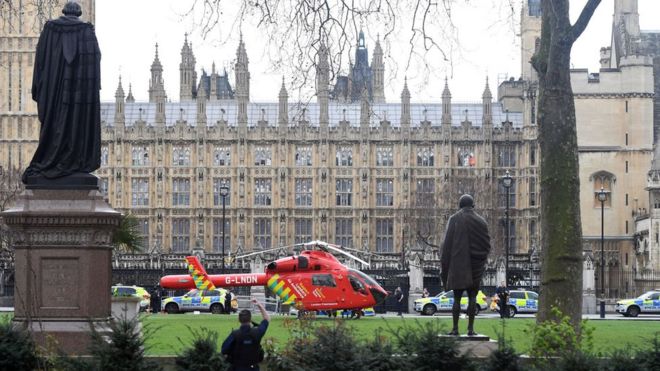 An air ambulance helicopter lands in the centre of Parliament Square