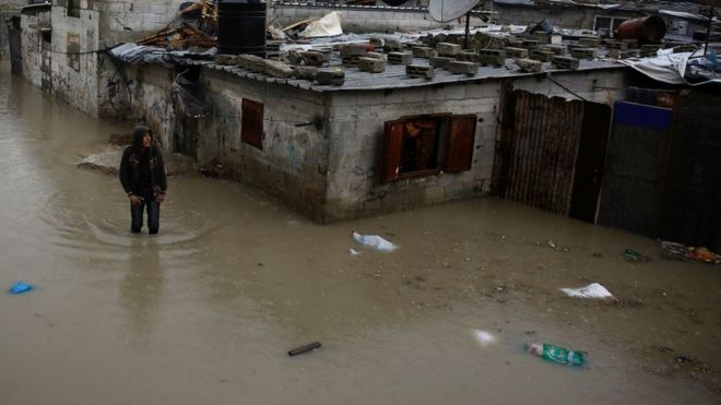 A man walks in a flooded area in northern Gaza, February 2017