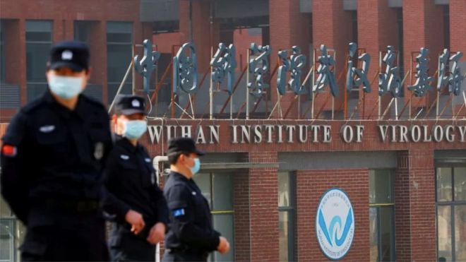 Policemen stand in front of the Wuhan Institute of Virology