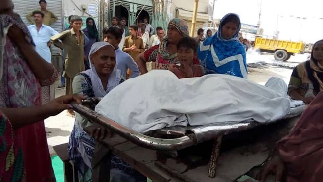Irfan Masih's body at the sit-in on 1 June. His mother is beside his body