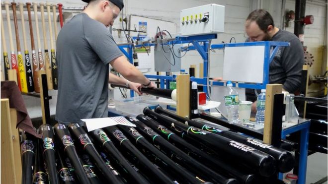 Men manufacturing baseball bats