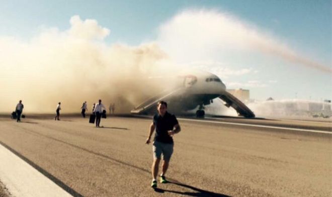 Пассажир бежит, как дым поднимается из самолета 9 сентября 2015