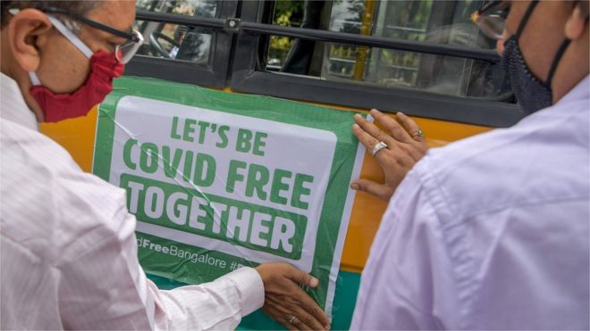 Officials put up a Covid public health sign in Bangalore, India
