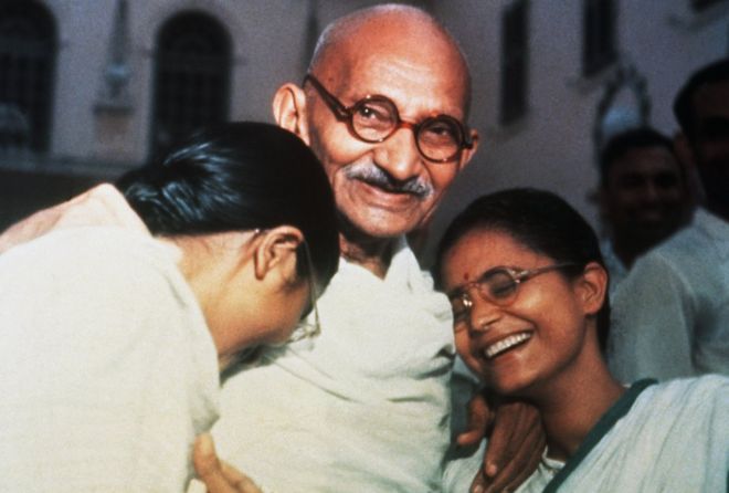 Mahatma Ghandi enjoys a laugh with granddaughters Manu [left) and Abha (right) at Birla House in New Delhi.