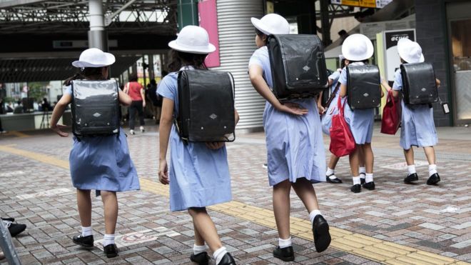 Schoolgirls walk home at Ebisu district in Tokyo on September 4, 2017.