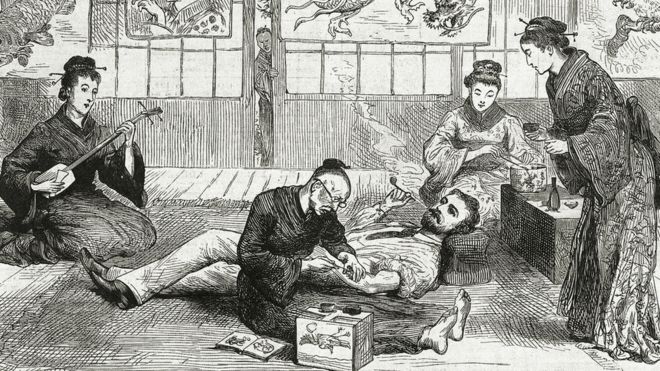 An artist tattoos a European visitor in Nagasaki, Japan in 1881 as geishas prepare tea (Credit: Pictorial Press Ltd/Alamy)