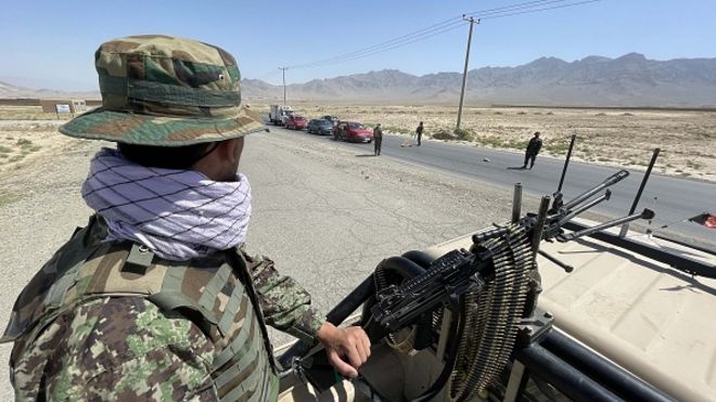 An Afghan soldier stands guard at a checkpoint