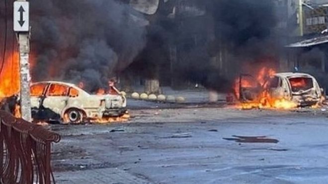 Burning vehicles after Russian strikes on Kherson