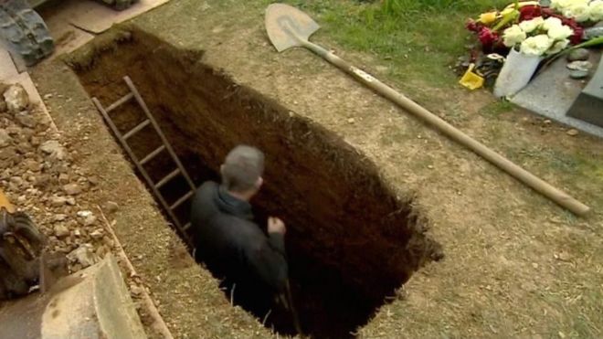 gravedigger digging a grave