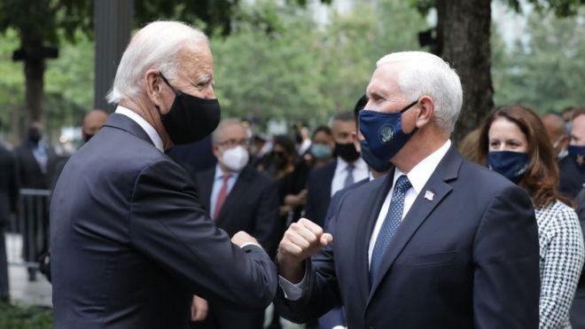 Democratic presidential nominee Joe Biden (L) and Vice President Mike Pence (R) greet each other during a 9/11 memorial service at the National September 11 Memorial and Museum on September 11, 2020 in New York City. The ceremony to remember those who were killed in the terror attacks 19 years ago will be altered this year in order to adhere to safety precautions around COVID-19 transmission