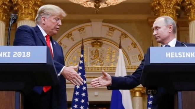 US president Donald Trump shakes Russian counterpart Vladimir Putin's hand