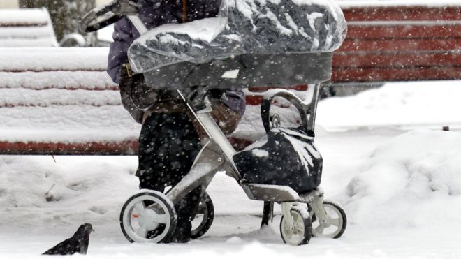 A mother with a buggy in snow (file photo)
