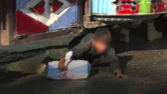 Child runs out from under a lorry