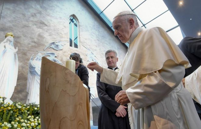 Pope Francis lights a candle at the Knock shrine