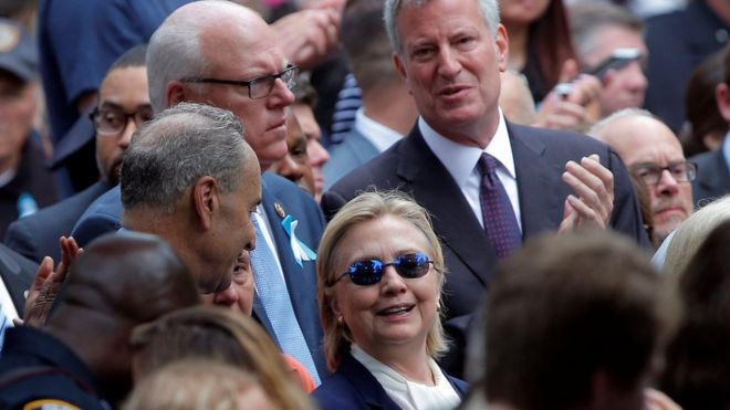 US Democratic presidential candidate Hillary Clinton and New York Mayor Bill de Blasio (R) attend ceremonies to mark the 15th anniversary of the September 11 attacks at the National 9/11 Memorial in New York, New York, 11 September