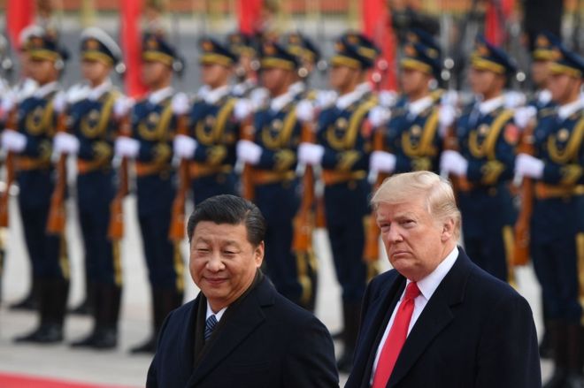 China's President Xi Jinping (L) and US President Donald Trump review Chinese honour guards during a welcome ceremony at the Great Hall of the People in Beijing on 9 November 2017.