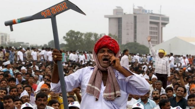 Член сообщества Patel, держащего ложный плуг, выкрикивает лозунги во время акции протеста в Ахмедабаде, Индия, 25 августа 2015 года.