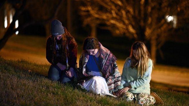 Children gather outside the Covenant School building at the Covenant Presbyterian Church following a shooting, in Nashville, Tennessee, on March 27, 2023.