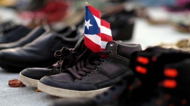 A Puerto Rican flag on a pair of shoes among hundreds displayed in memory of those killed by Hurricane Maria in front of the Puerto Rican Capitol, in San Juan (file photo)